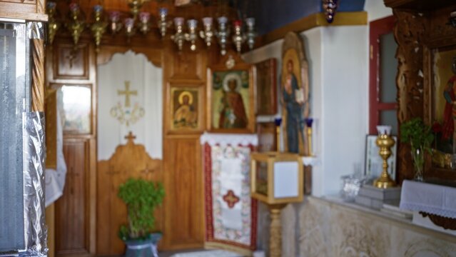 Soft blurred church interior featuring wooden iconostasis, painted icons and altar, defocused background; background backdrop copyspace calm.