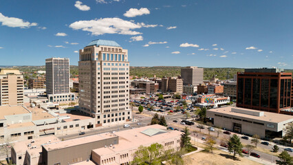 Close aerial view of Colorado Springs downtown skyline with high rise office tower and city streets © Viola