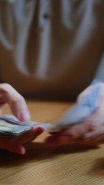 Man counts money with hands, trader or businessman counts salary banknotes. Male counting USD cash. Business crisis finance. Close-up of lifestyle, hand counting paper dollars, american paper