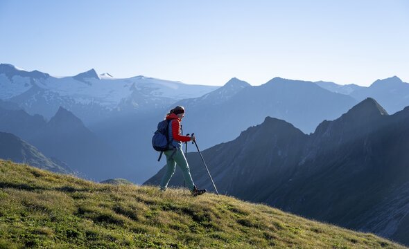 Hiker enjoying the mountain panorama in the morning, Venediger group, behind Dreiherrenkopf, Simonysitze and Gro&szlig;er Geiger, Hohen Tauern, Austria
