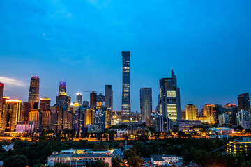 Obraz premium Night view of the Beijing Central Business District skyline at blue hour, featuring the China Zun skyscraper and illuminated modern office towers in Beijing, China.