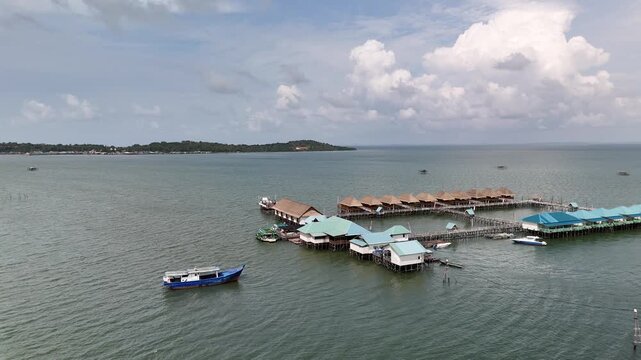 Aerial View: Boat Moving Near Waterfront Resort in Batam, Indonesia - 4K