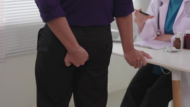 A man consulted a doctor about the treatment for hemorrhoids and anal pain at a clinic. The middle-aged man complained of hemorrhoid pain when palpating his lower back and buttocks.