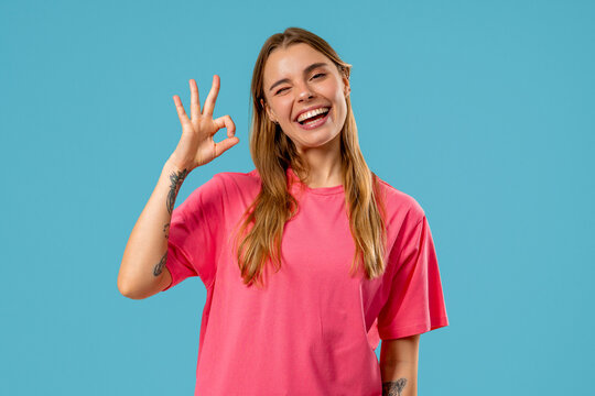 Positive woman forms OK, OKay hand sign, smiling confident. Confirmation,success