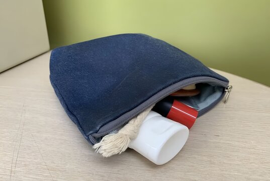 Personal care travel pouch with beauty products peeking out