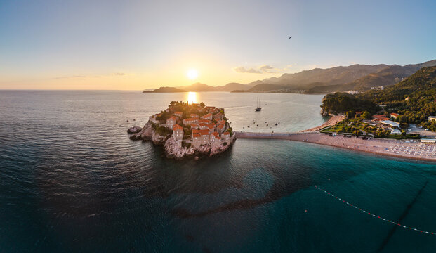 Aerial drone view of Sveti Stefan island at sunset on the Adriatic coast of Montenegro. 