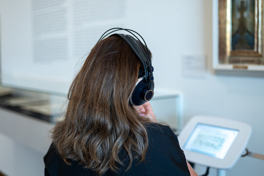 Visitor receives information about artworks through a museum audio guide.