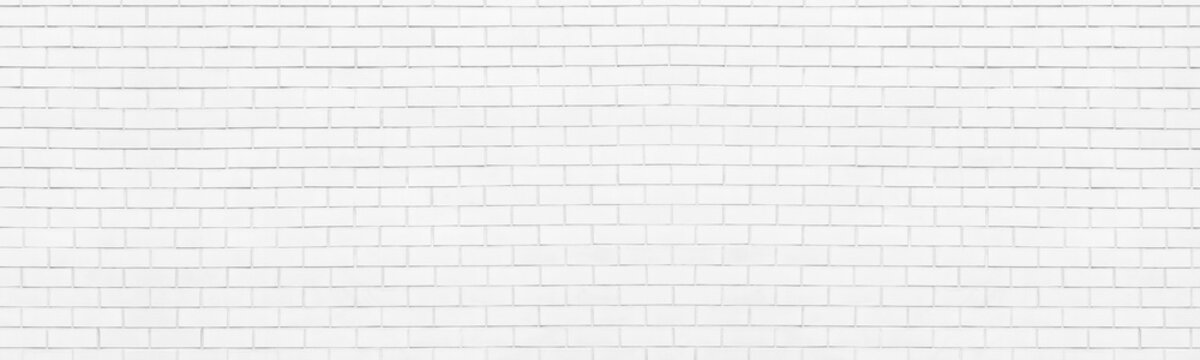 White painted brick wall wide panoramic texture. Whitewashed brickwork widescreen wallpaper. Light masonry large long backdrop. High key abstract grunge background