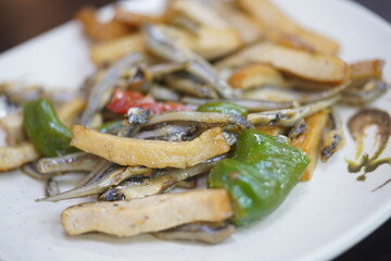 Fototapeta premium Close up of traditional Taiwanese side dish stir fried dried anchovies with dried tofu and green peppers