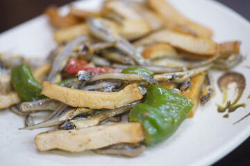 Fototapeta premium Close up of traditional Taiwanese side dish stir fried dried anchovies with dried tofu and green peppers