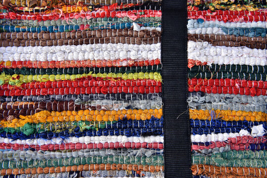Colorful Handmade Rag Rug Texture with Black Strap.