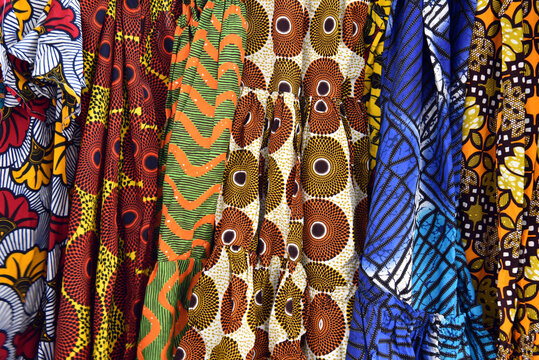Vibrant Colorful African Wax Print Fabrics and Dresses on Display.