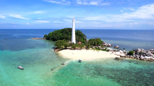 Belitung Island tropical landscape of Lengkuas Island from above, showing the iconic lighthouse surrounded by clear blue ocean