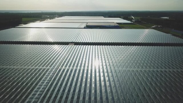 Drone takeoff over large greenhouse roof area