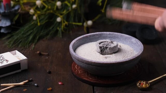 Frankincense and resins burning on glowing charcoal - placing charcoal and incense
