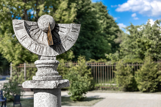 Vidnoye, Moscow, Russia - June 05, 2026: vertical sundial made of stone. sundial shows time. the shadow of the gnomon moves across the dial. 