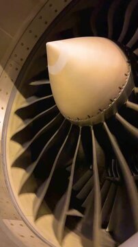 Industrial close up shot of spinning airplane turbofan engine front view commercial passenger aircraft turbine component detail engineering technology concept 4k clip
