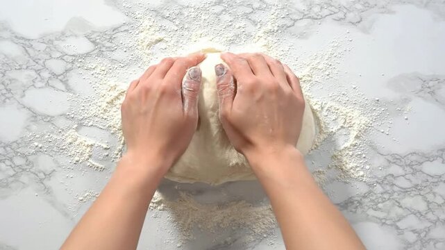 Close-Up Of Hands Kneading A Soft Elastic Ball Of Dough On A Marble Countertop, Showcasing The Art Of Baking