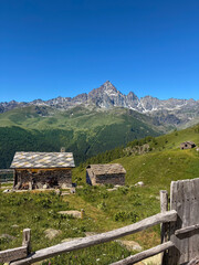 View of Monviso mountain peak (Cottian Alps), rising above traditional alpine stone houses, known as meire, Piedmont, Italy.  © framarzo