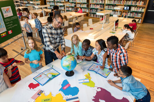 Diverse children learning geography together.