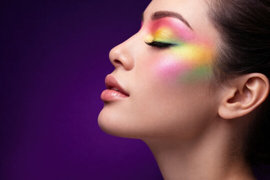 Vibrant rainbow makeup on model.