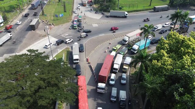 Cikarang, Indonesia - June 18, 2026: Aerial view of heavy truck traffic and congestion at a major industrial intersection in Cikarang during daytime
