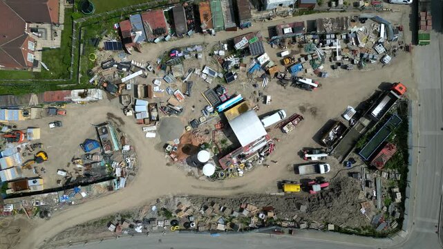Aerial shot of the storage site at Noble Homes in Knottingley UK. The area shows construction materials and vehicles. This is a busy site with various activities taking place