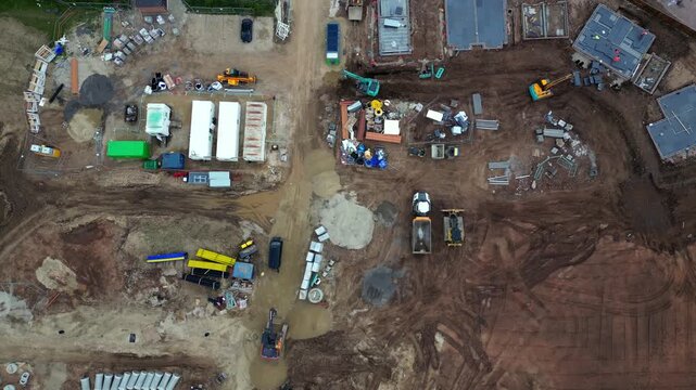 A construction site in Boroughbridge with different types of machinery and equipment. The area is busy with activity and shows materials spread out across the yard