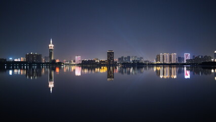 Fototapeta premium The night city view with the reflection in water at night