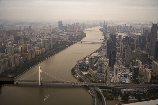 Aerial view of the Liede Bridge spanning the Pearl River with modern skyscrapers and urban development in Guangzhou, Guangdong Province, China.