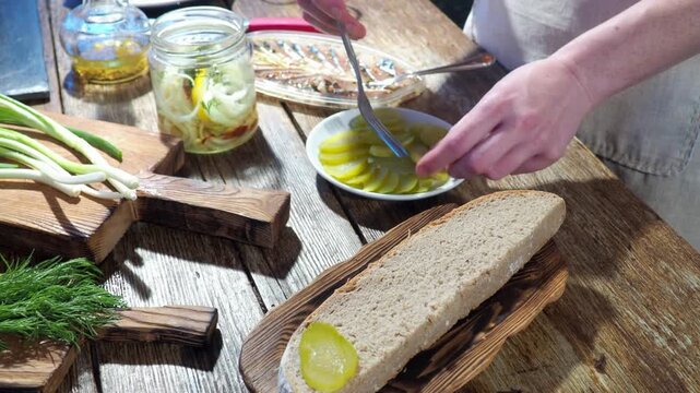 A rustic wooden table with a plate of pickled vegetables and bread