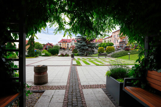 TRZEBINIA, POLAND - JUNE 13, 2026: Grand urban pergolas fully covered in climbing plants, providing shade from the hot summer sun and comfortable seating inside.