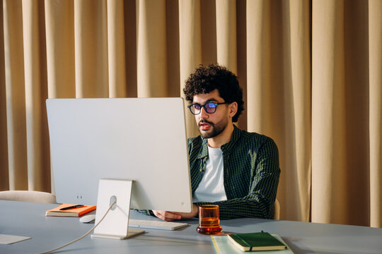 A man is talking on a video chat in the office
