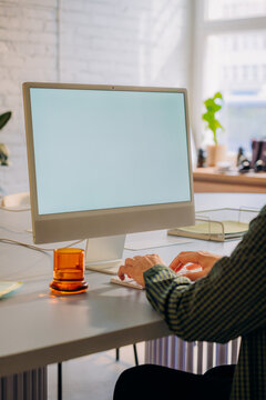 A computer monitor with a white screen on the table