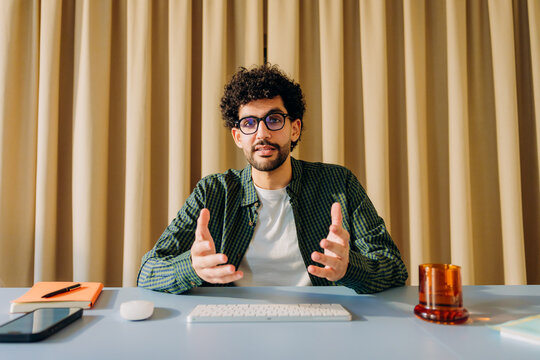 A man is talking on a video chat in the office