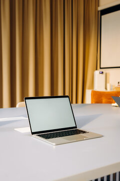 A laptop with a white screen on a desk