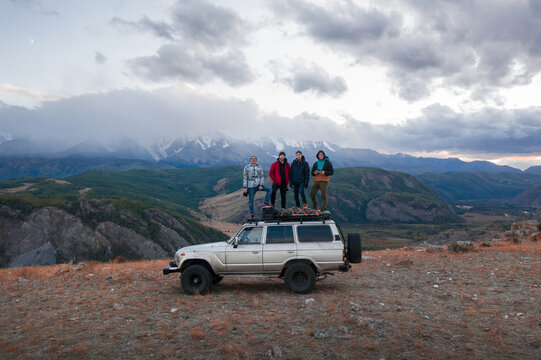 A group of tourists in the mountains on a road trip