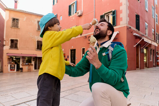 Father and child eating ice cream