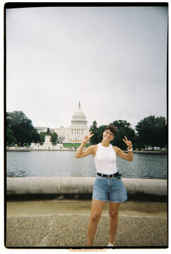 Happy woman making peace sign at US Capitol, Washington DC