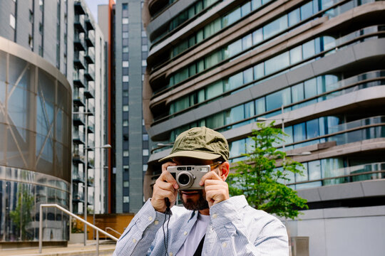 Tourist photographing corporate towers in London