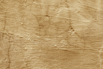Rough tan plastered wall texture with cracks and uneven paint suitable for backgrounds, textures, architectural designs, and interior decor projects. © Dinamartina93