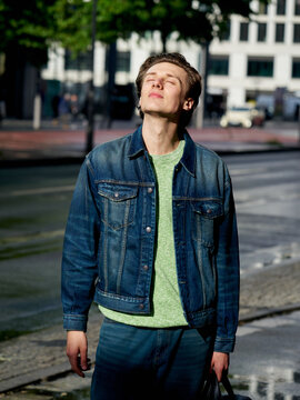 Young Person Enjoys Sunshine in Urban Street Setting