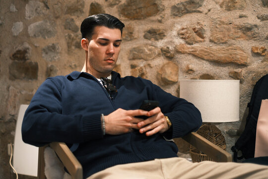 Young Man Using Smartphone Indoors