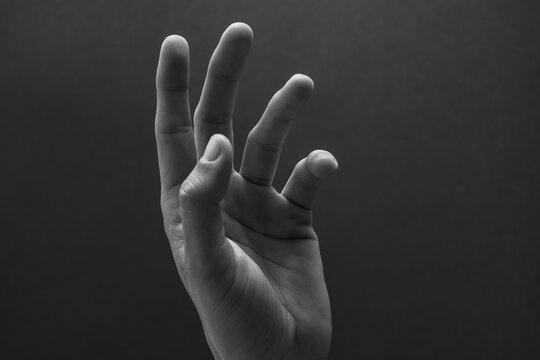 Hand reaching out with fingers spread open 