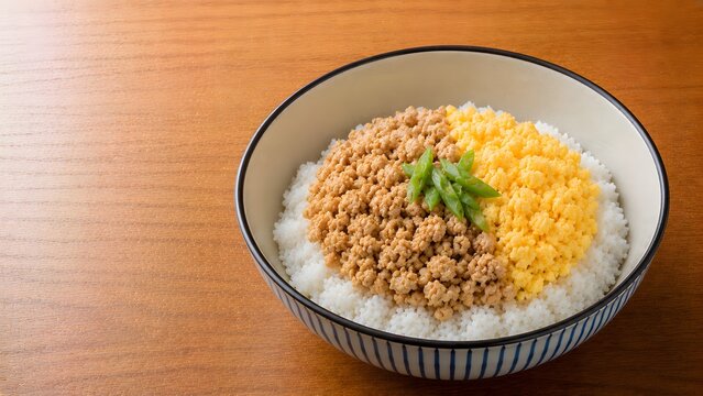 classic japanese soboro don with minced chicken and scrambled egg layers over rice