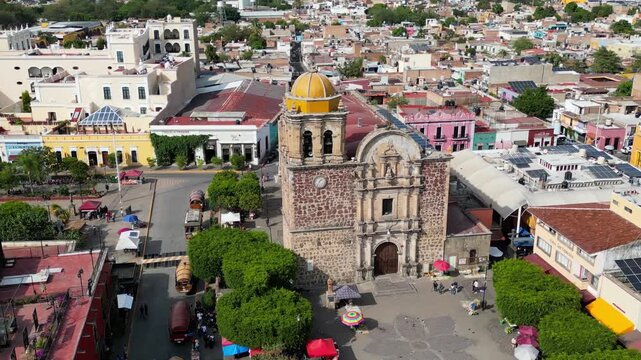Tequila, Mexico - March 29 2026: Captivating drone aerial view circling Santiago Apostol Parish Church in the historic town of Tequila, Jalisco. Showcases vibrant architecture and cultural heritage.