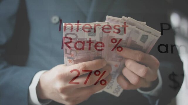 Close-up of a businessman's hands counting a stack of Euro banknotes with a red "Interest Rate 43%" text overlay. Represents concepts of inflation, borrowing costs, and global financial crisis.