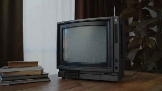 Retro TV, vintage television In a nostalgic setup, a retro TV displays grain on screen, scary halloween night device good for chroma key and green screen.