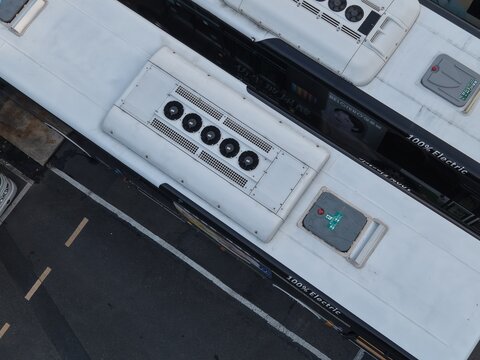 Aerial view of electric bus rooftops with 100 percent electric text.