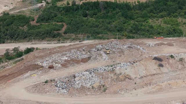 Garbage piles grow on land near construction site in rural area in the summer